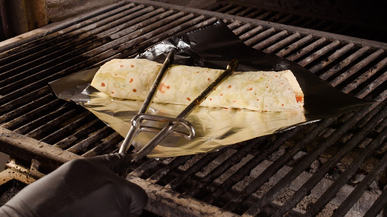 Burrito with foil on grill