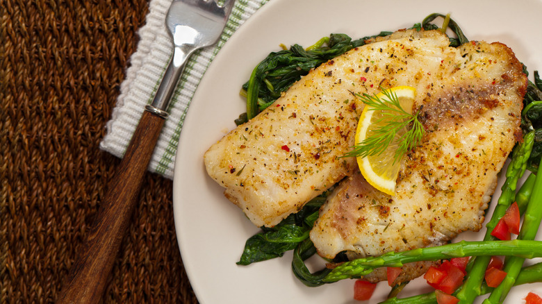 cooked tilapia and asparagus on a plate