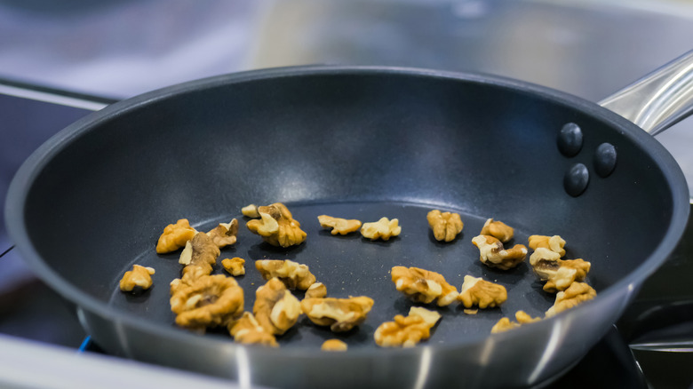 Roasting walnuts in a pan