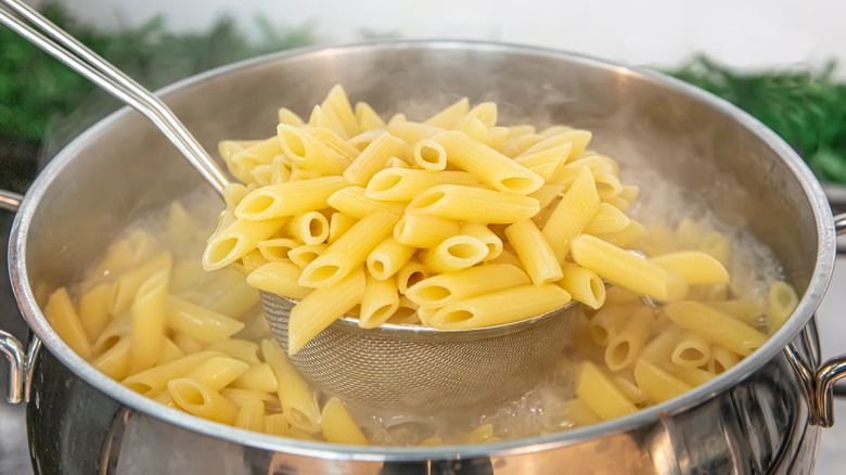 Straining penne from pot