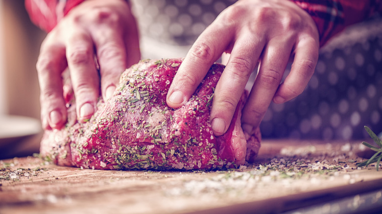 covering roast with salt and herbs