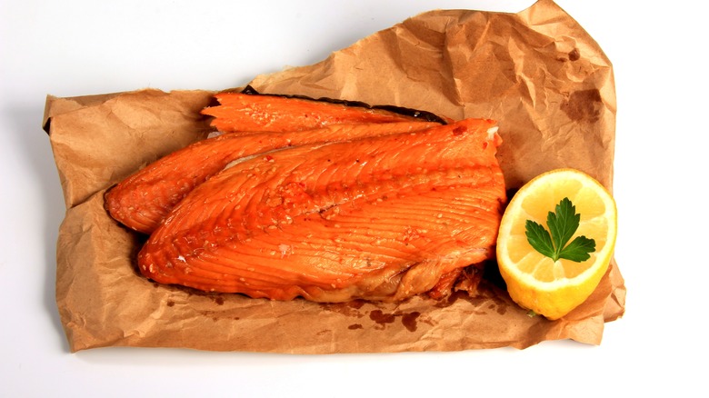 hot-smoked salmon on brown paper with lemon