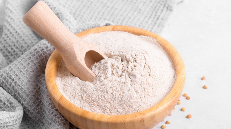 wheat flour in wooden bowl