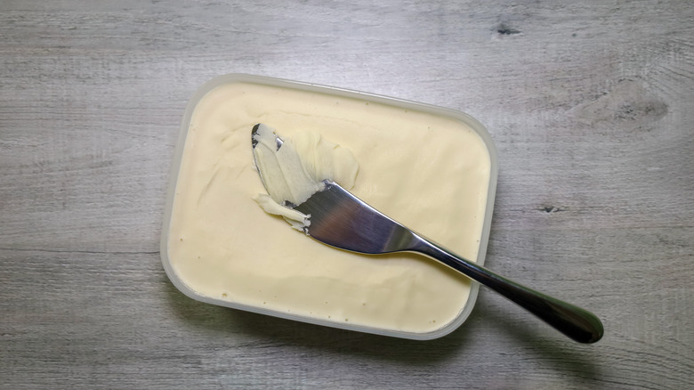 Knife in carton of butter
