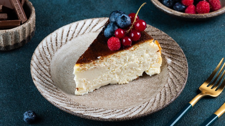 A slice of perfect cheesecake topped with fruit 