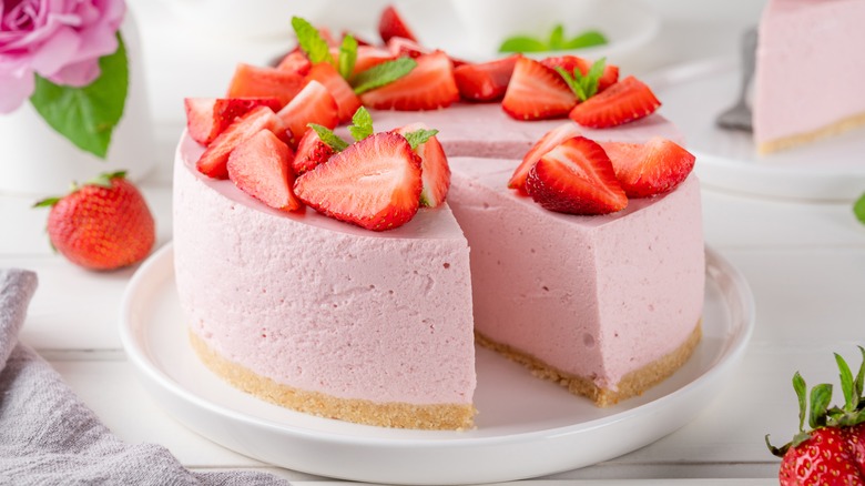 A pink no-bake cheesecake topped with strawberries