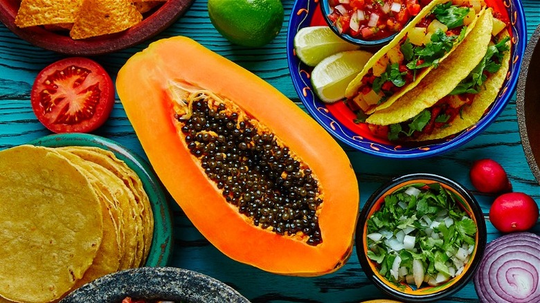 Mexican feast with half sliced papaya 