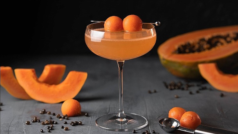 Scooped papaya garnish on cocktail