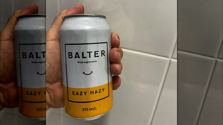 Person holding beer in shower