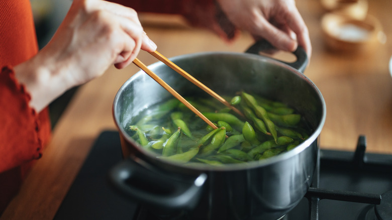 person cooking with chopsticks