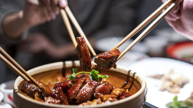 holding meat with chopsticks