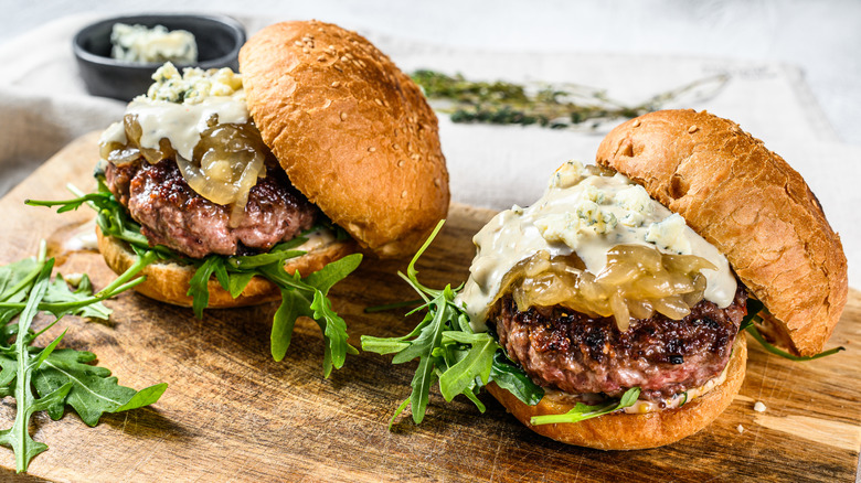 Two burgers with blue cheese