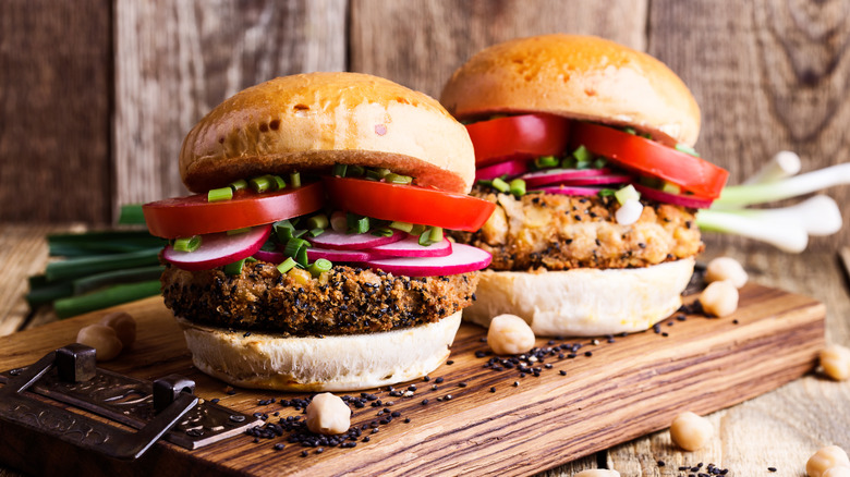 two veggie burgers served on wooden board