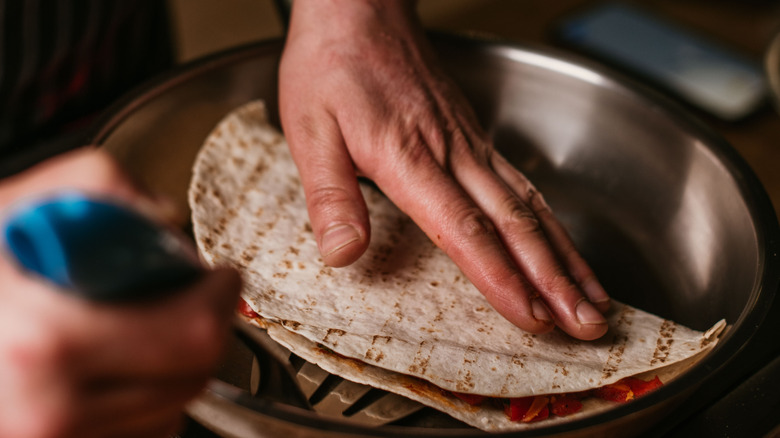 turning quesadilla in frying pan