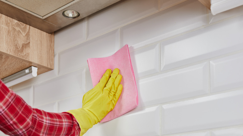 Wiping down kitchen tiles