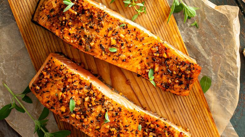 Seasoned fish on wooden cutting board 