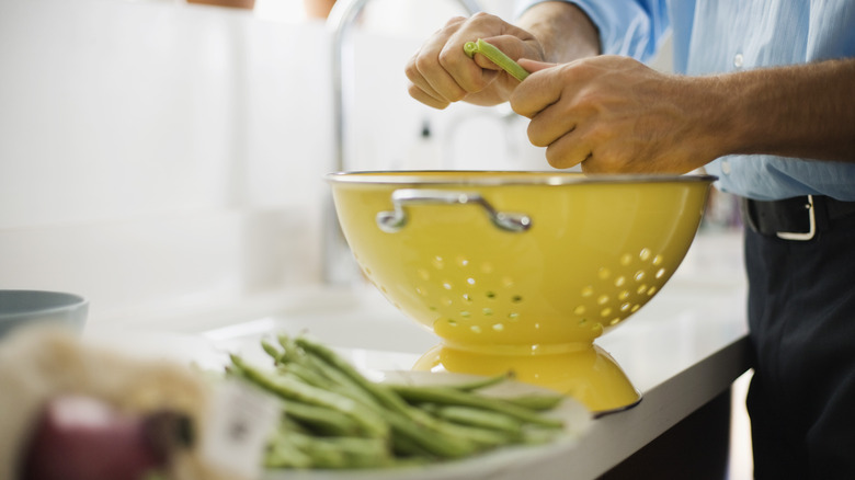 preparing beans with colander