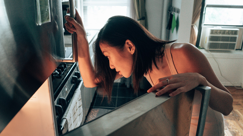 woman looking inside refrigerator