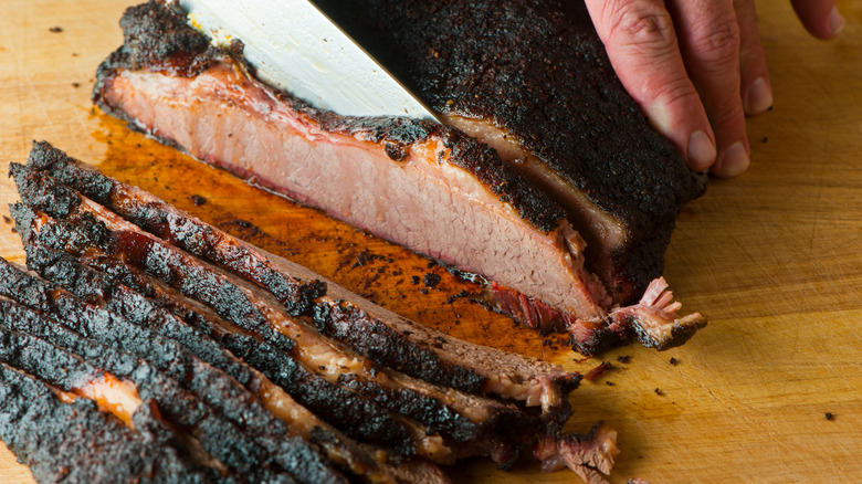 Slicing brisket on cutting board