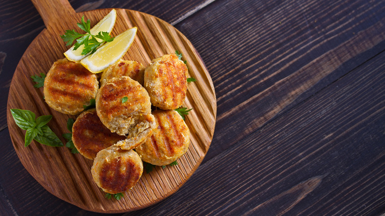 Crab cakes on a wooden board