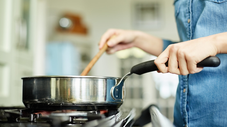 stirring pan on stove top