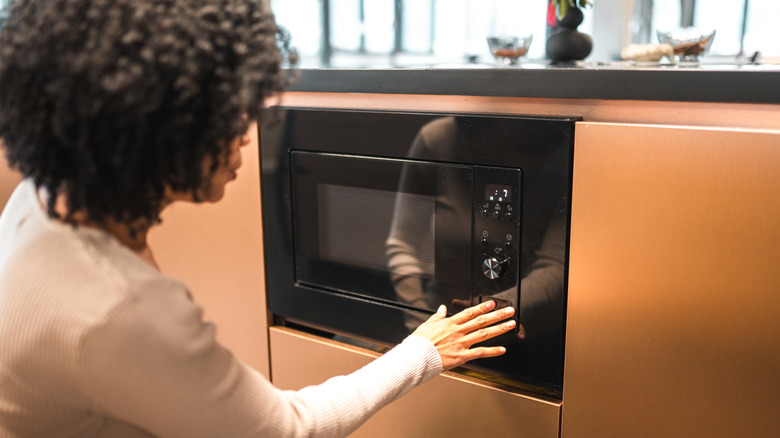 woman using microwave