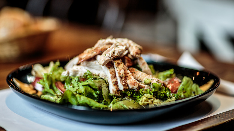 Salad topped with roast turkey