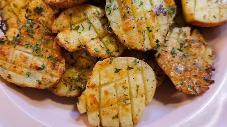 Cooked and seasoned potatoes scored in a grid pattern