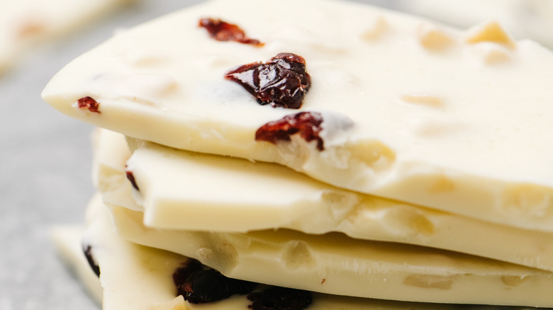 A stack of white chocolate bars pieces filled with dried cranberries