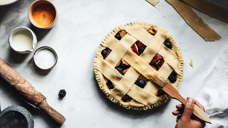 Hand brushes fruit pie