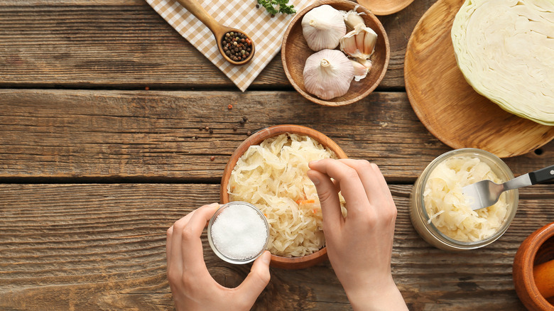 hands preparing sauerkraut 