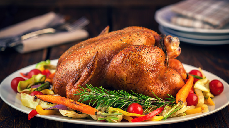 Roasted chicken on a plate of veggies