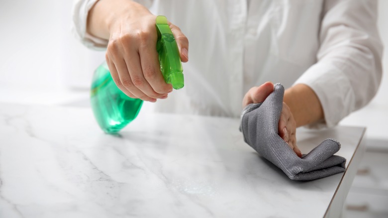 Person cleaning a marble counter