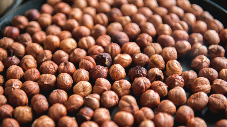 roasted hazelnuts on black pan