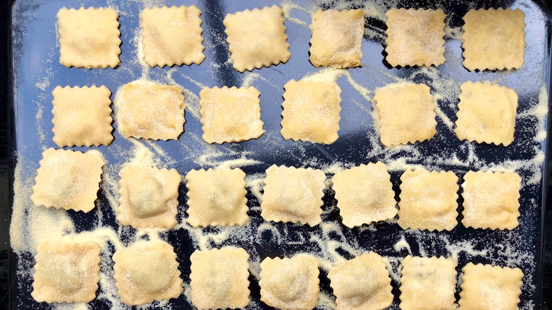 uncooked ravioli on baking sheet