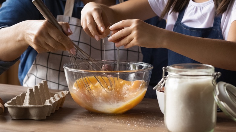 Adult and child baking together