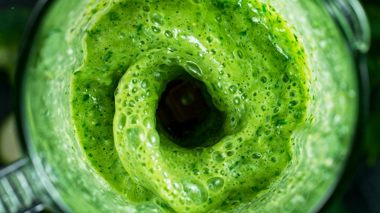 green liquid being pureed in blender