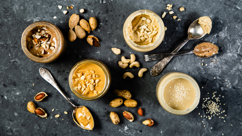 Jars and spoonfuls of nut butters