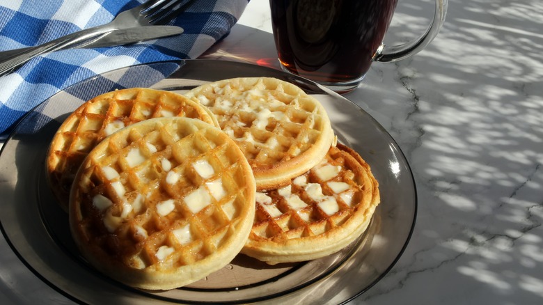 Two buttered Eggo waffles on blue plate