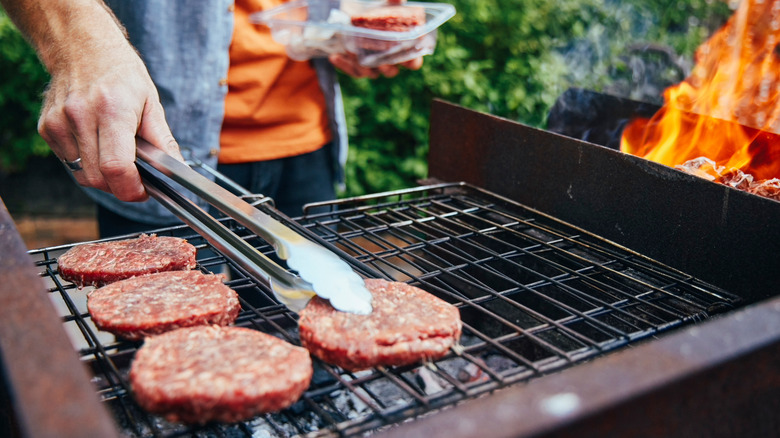 Burgers cooking on charcoal grill