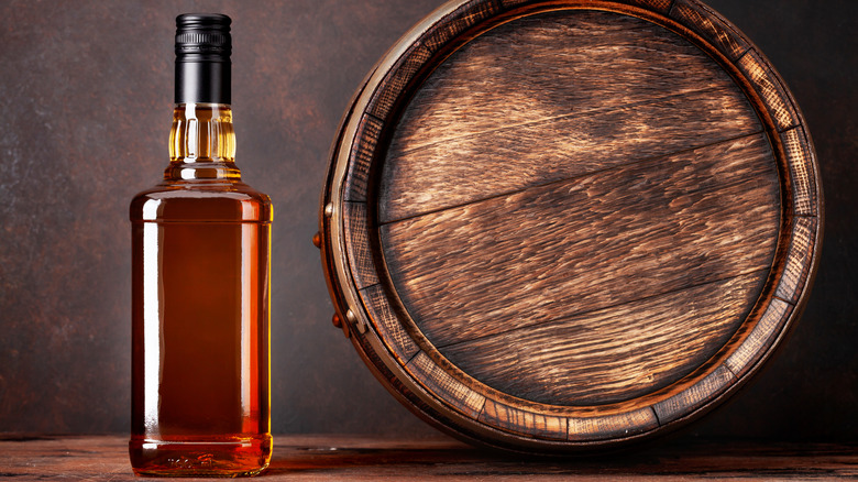 Bottle of whisky and barrel