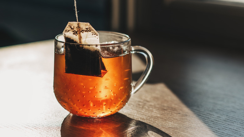 Tea bag in glass cup.