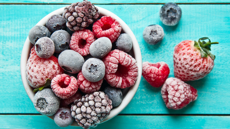 Frozen berries in a small bowl on table