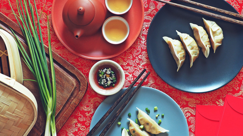 Dumplings and tea on red cloth