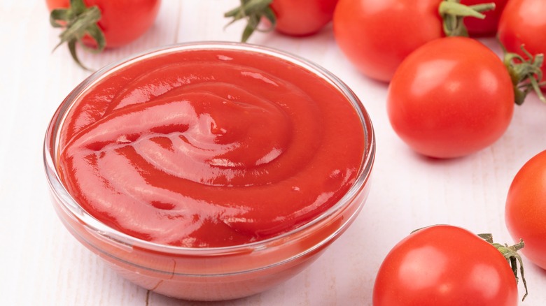 Ketchup surrounded by tomatoes