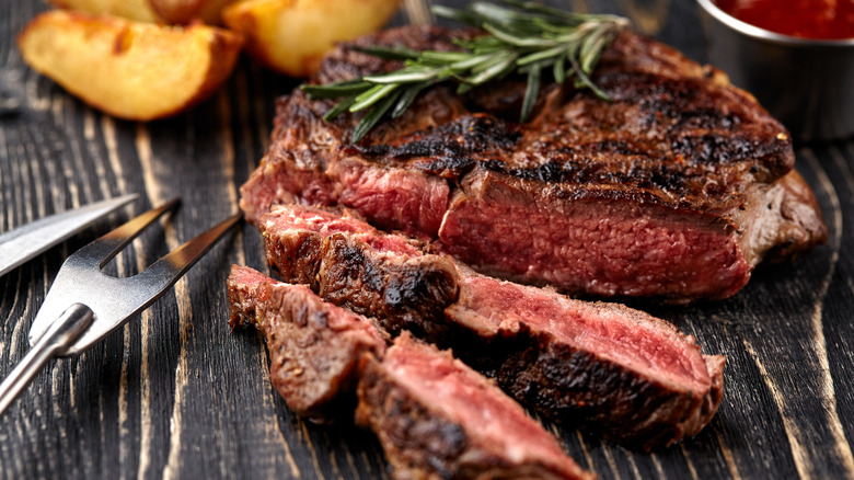 crispy browned steak cut on board