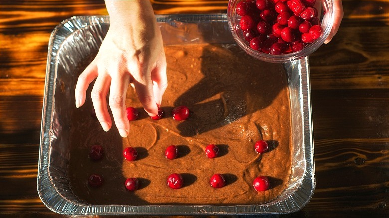 Brownie batter with cherries in pan 