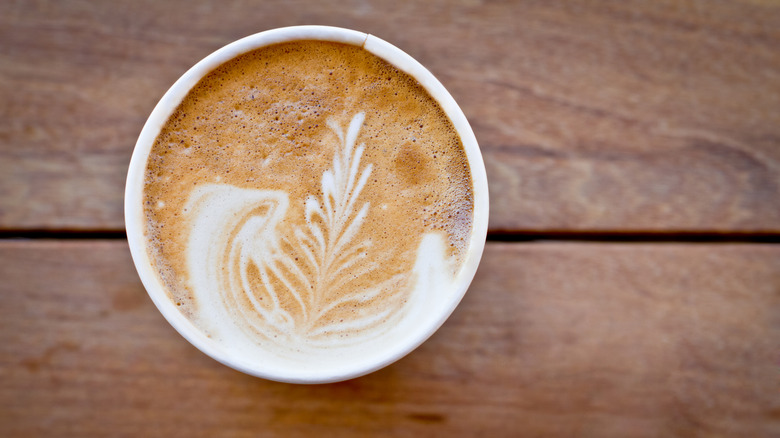 overhead shot of a latte in a to-go cup