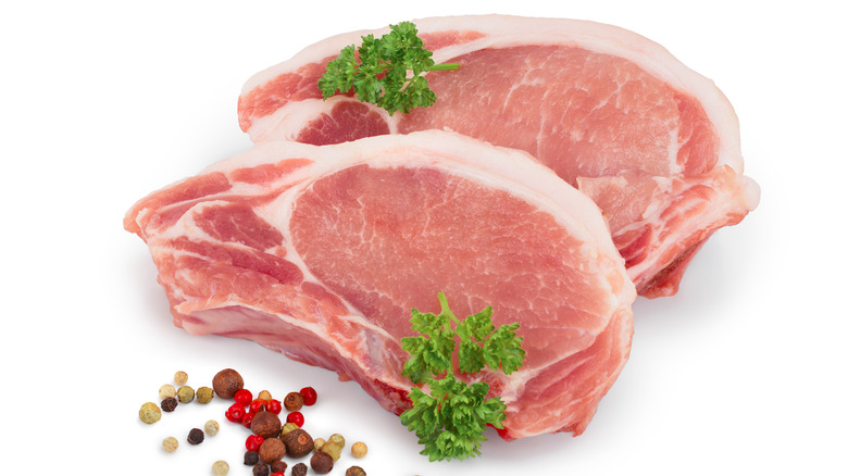 Raw pork chops and spices