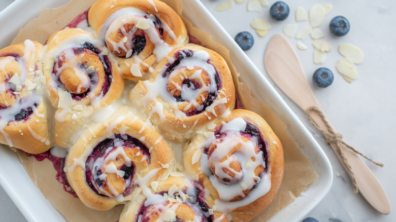 Blueberry filled cinnamon rolls in a baking dish